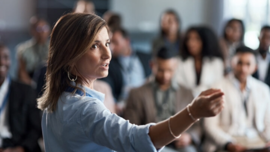 Trainer leading a diverse group of managers through a conflict resolution training session